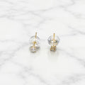 10K yellow gold 3mm round CZ stud earring worn on ear showing petite scale and fit