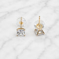 10K yellow gold princess-cut CZ stud earrings front and back view with clear disc push backs on marble surface