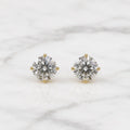10K yellow gold 5mm round CZ stud earrings in polished four-prong settings on white marble surface