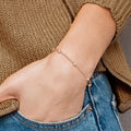 14K rose gold lab grown diamond station bracelet worn on wrist showing delicate scale and fit