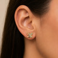 14K tri-color gold CZ butterfly stud earring worn on ear showing everyday scale and fit