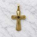 Back view of 14K two-tone gold crucifix pendant showing brushed finish and polished beveled edges on white marble surface