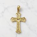 Back view of 14K two-tone gold cross pendant with white gold geometric detailing and open-heart center on marble