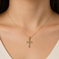 14K two-tone gold heart cross pendant worn on a fine chain at the neckline showing petite scale and fit