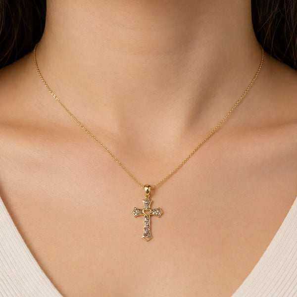 14K two-tone gold heart cross pendant worn on a fine chain at the neckline showing petite scale and fit