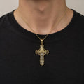 14K two-tone gold filigree crucifix pendant with white gold corpus worn on a gold cable chain over a black crew-neck shirt