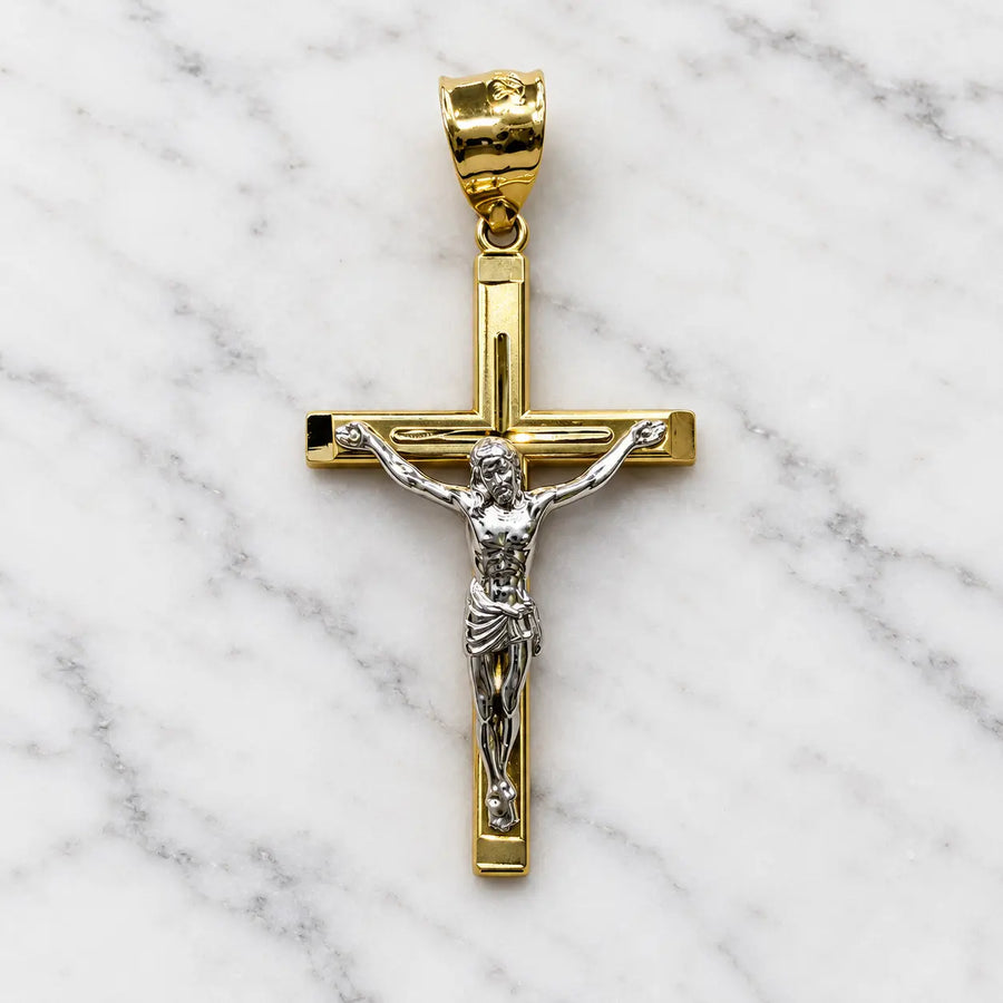 Front of a 14K two-tone gold crucifix pendant with a white gold corpus on a polished grooved cross