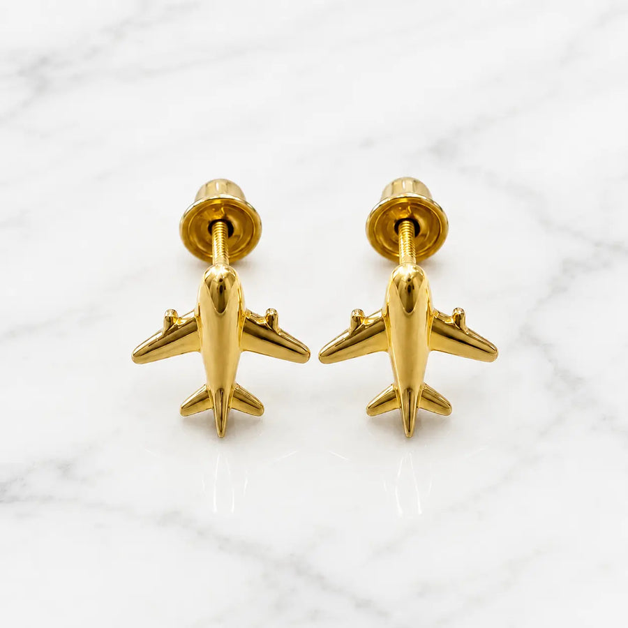 14K yellow gold airplane screw back stud earrings with polished airplane design on marble surface