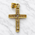 Back view of 14K yellow gold baguette CZ cross pendant showing stone settings and tapered bail on white marble surface