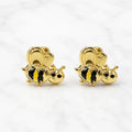 14K yellow gold bee stud earrings with black enamel accents and polished wings on marble surface