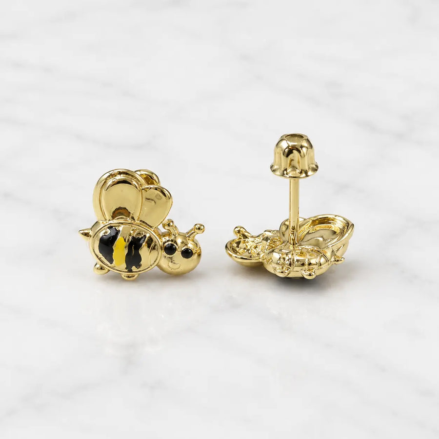14K yellow gold bee stud earrings with black and yellow striped detail and screw backs on marble surface