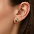 14K yellow gold bee stud earring worn on ear showing black and yellow striped detail and size