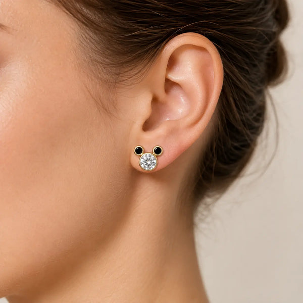 14K yellow gold clear and black CZ mouse ear stud earring worn on ear showing scale and fit