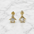 14K yellow gold CZ penguin screw back stud earrings front and back view with oval body on marble surface