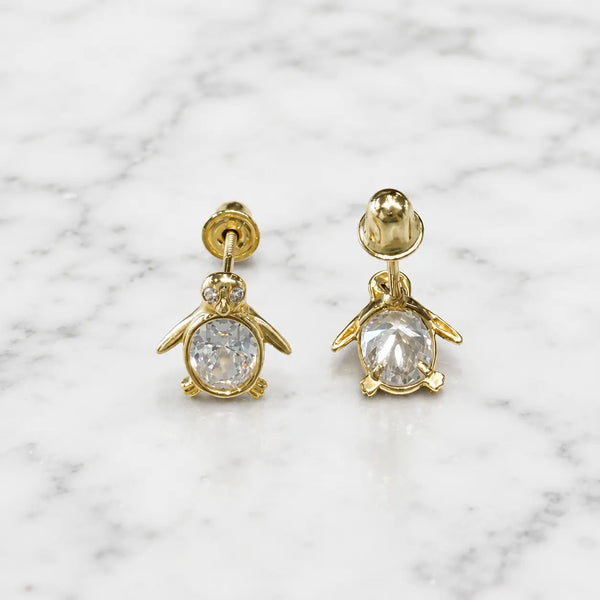 14K yellow gold CZ penguin screw back stud earrings front and back view with oval body on marble surface
