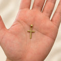 14K yellow gold diagonal textured cross pendant held in hand showing its approximately 26.1mm height