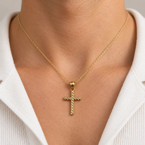 14K yellow gold textured cross pendant worn on a fine chain showing its petite scale and fit