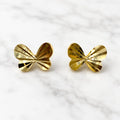 14K yellow gold diamond-cut butterfly stud earrings with faceted polished wings on marble surface
