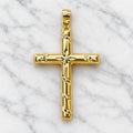 14K yellow gold diamond-cut cross pendant with starburst center and polished tubular arms on white marble surface