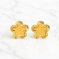 14K yellow gold diamond-cut flower stud earrings with scalloped polished petals on marble surface