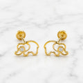 14K yellow gold elephant screw back stud earrings with open outline and clear CZ center on marble surface