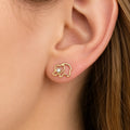 14K yellow gold elephant CZ stud earring worn on ear showing hidden heart detail and scale