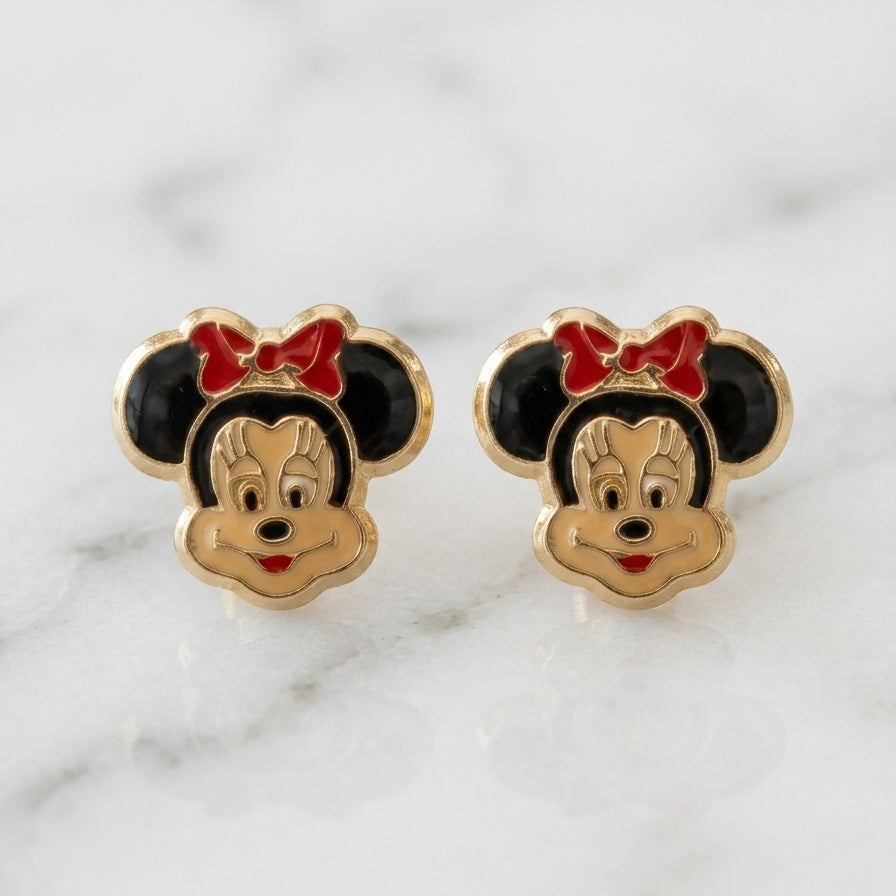 14K yellow gold enamel mouse face stud earrings with black ears and red bow detail on marble surface