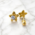 14K yellow gold flower CZ stud earrings front and back view on marble showing round CZ center and screw-back closure