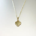 14K yellow gold four-leaf clover necklace showing smooth polished gold back face with milgrain beaded border on display bust