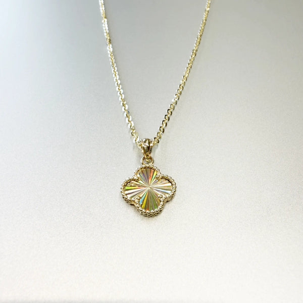 14K yellow gold four-leaf clover pendant necklace with diamond-cut sunburst front showing prismatic rainbow light effect on display bust