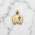 Back of the 14K yellow gold Holy Bible pendant showing its hollow recessed back, the pierced cross, and the 14K-stamped bail