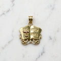 Front of a 14K yellow gold Holy Bible pendant shaped as an open book with raised HOLY BIBLE lettering, a pierced cross, and scroll filigree