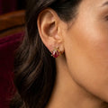 14K yellow gold ladybug red CZ stud earring worn on ear showing size and dimensional detail