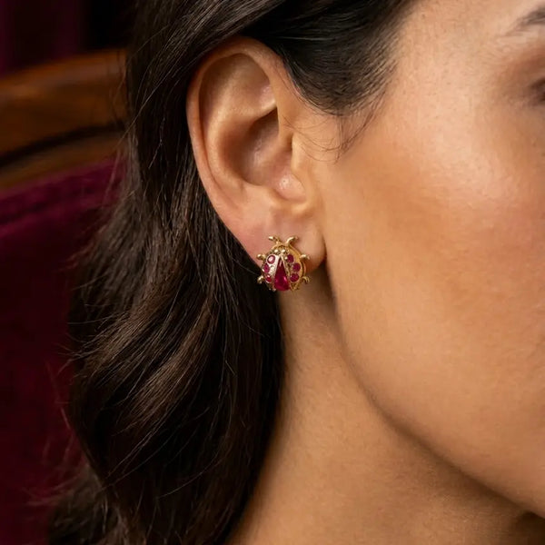 14K yellow gold ladybug red CZ stud earring worn on ear showing size and dimensional detail