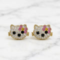 14K yellow gold multicolor CZ cat face stud earrings with pink bow and black accents on marble surface