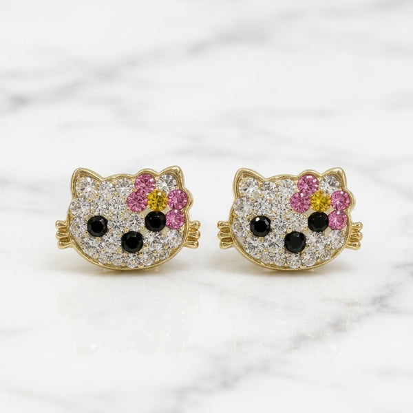 14K yellow gold multicolor CZ cat face stud earrings with pink bow and black accents on marble surface