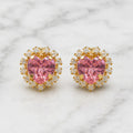 14K yellow gold pink CZ heart halo stud earrings with clear CZ accent stones on marble surface