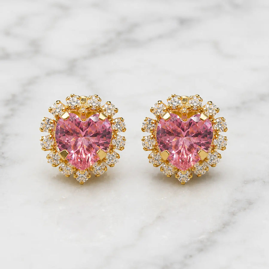 14K yellow gold pink CZ heart halo stud earrings with clear CZ accent stones on marble surface