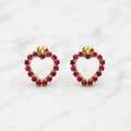 14K yellow gold pink CZ heart screw back stud earrings with open heart design on marble surface