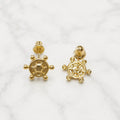 14K yellow gold ship wheel screw back stud earrings front and back view on marble surface