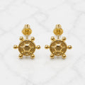 14K yellow gold ship wheel screw back stud earrings with polished nautical design on marble surface