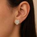 14K yellow gold white CZ heart halo stud earring worn on ear showing size and sparkle