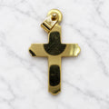 Back view of 14K yellow gold polished cross pendant showing flat polished back and hinged bail on white marble surface