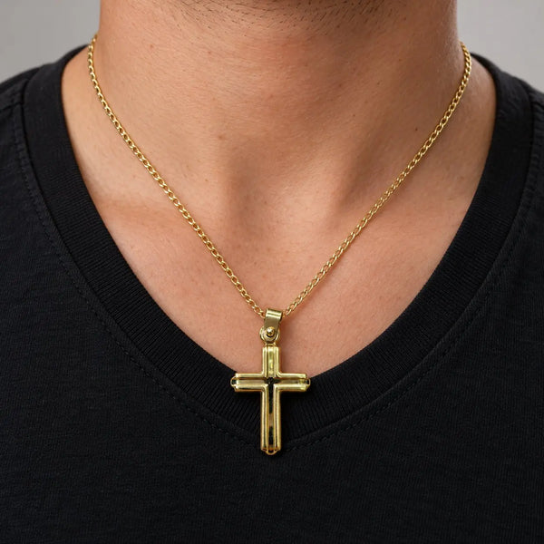 14K yellow gold polished grooved cross pendant worn on a gold chain at a man's neckline over a black shirt