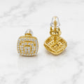 Gold tone over sterling silver moissanite cushion stud earrings front and back view showing screw-back closure on marble surface