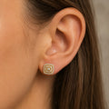 Gold tone over sterling silver moissanite cushion cluster stud earring worn on ear showing scale and fit