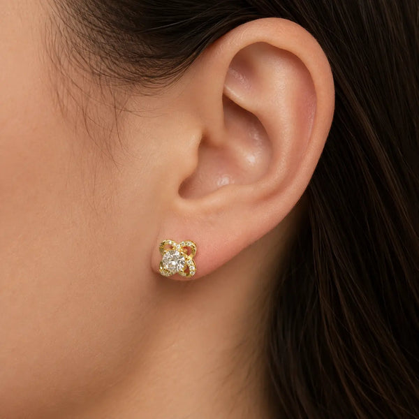 Gold tone over sterling silver moissanite floral stud earring worn on ear showing 7.6mm scale and fit