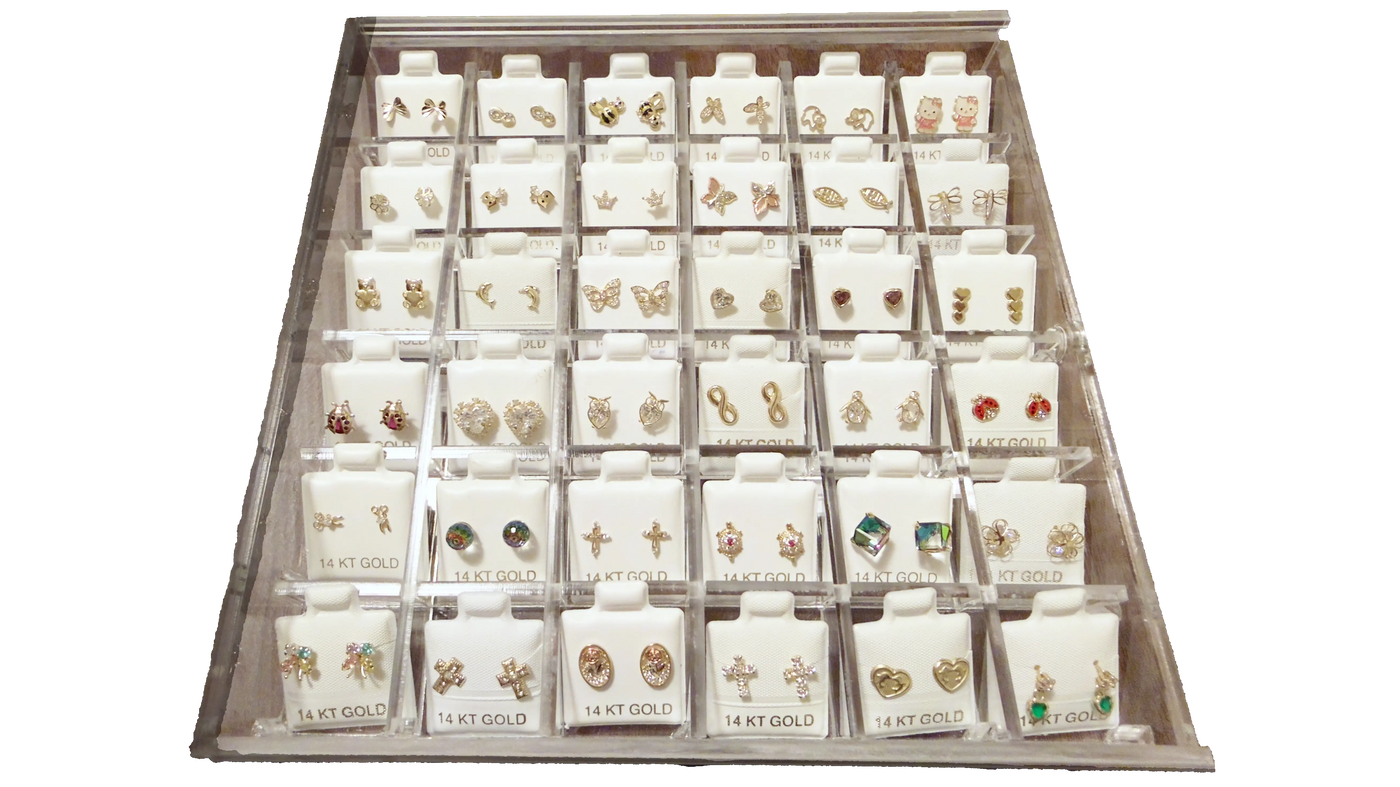 Display case with various pairs of earrings on white background