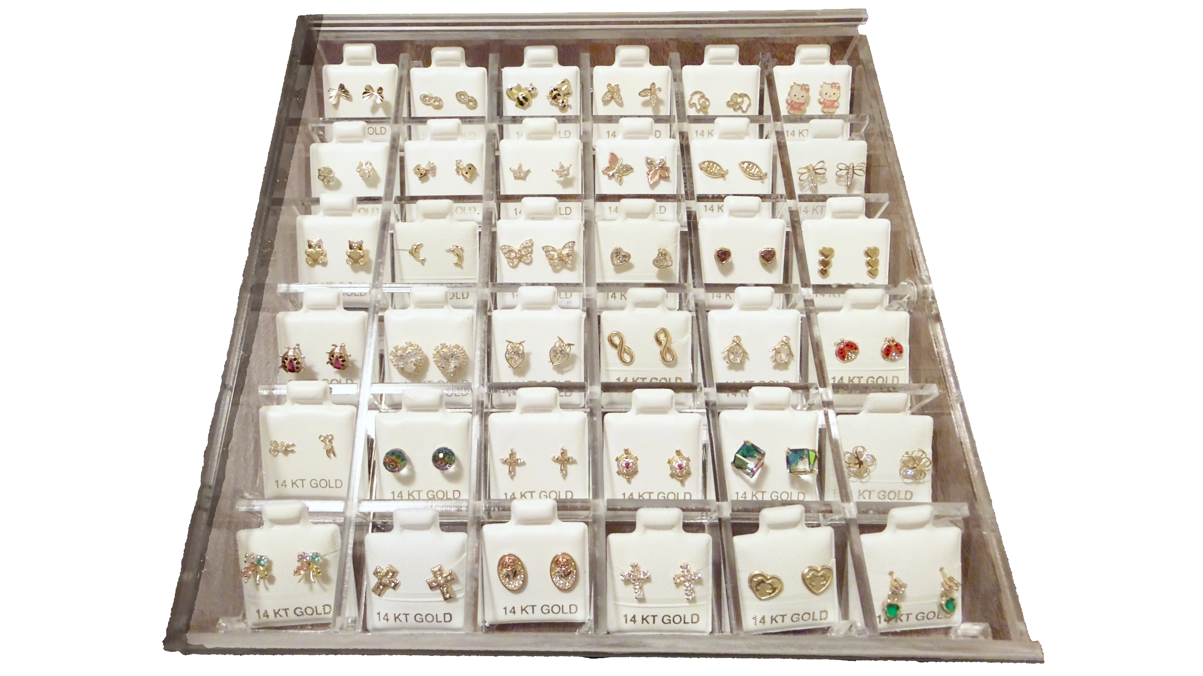 Display case with various pairs of earrings on white background