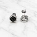 Sterling silver black CZ pavé halo stud earrings with push-back post detail on marble surface